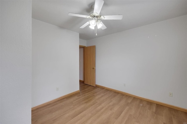 spare room with light wood-type flooring and ceiling fan