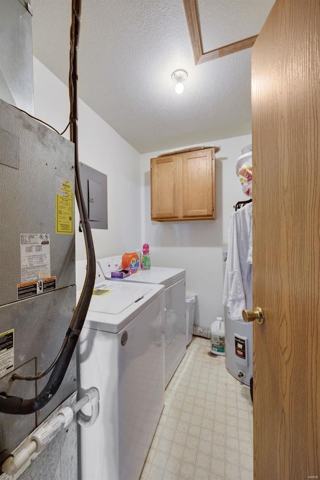 laundry room featuring washer and clothes dryer, cabinets, a textured ceiling, and electric panel