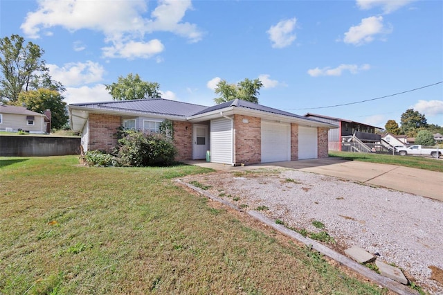 ranch-style house featuring a garage and a front lawn