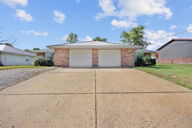 view of front of home with a front yard and a garage