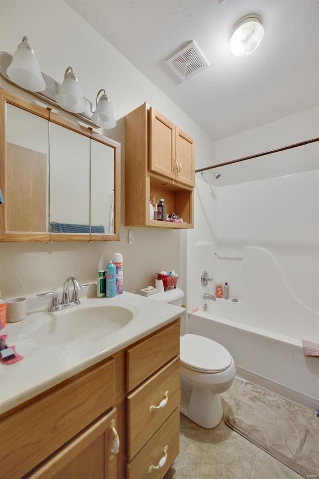 full bathroom featuring vanity, tile patterned floors, shower / bath combination, toilet, and a textured ceiling