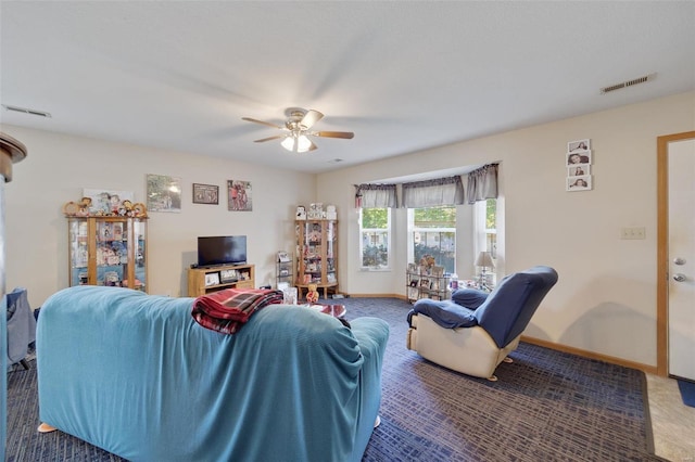 carpeted living room with ceiling fan