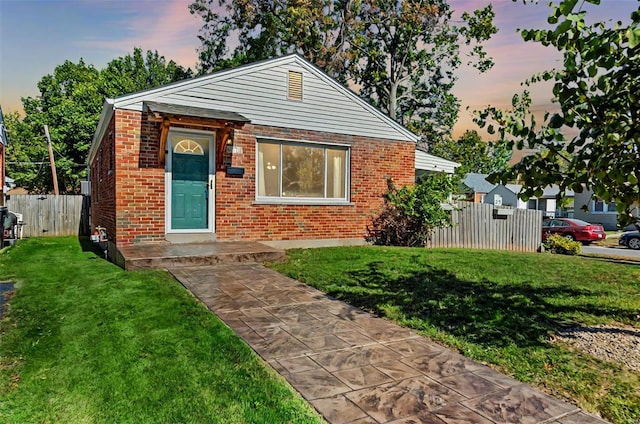 bungalow-style house with a lawn