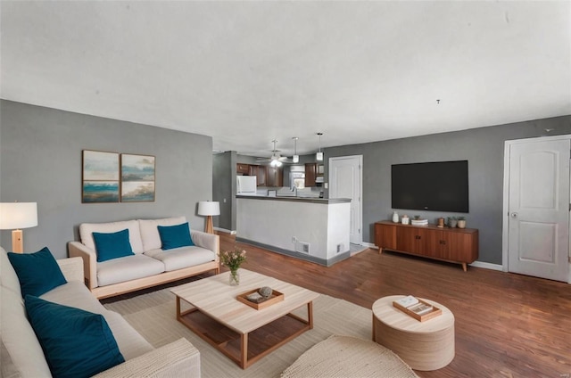 living room featuring hardwood / wood-style flooring and ceiling fan