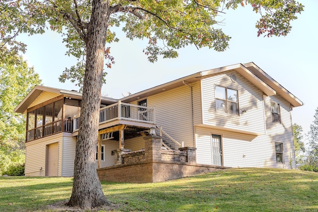 back of house featuring a yard and a deck