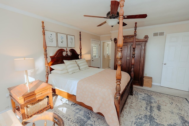 bedroom featuring ceiling fan, ornamental molding, and light carpet