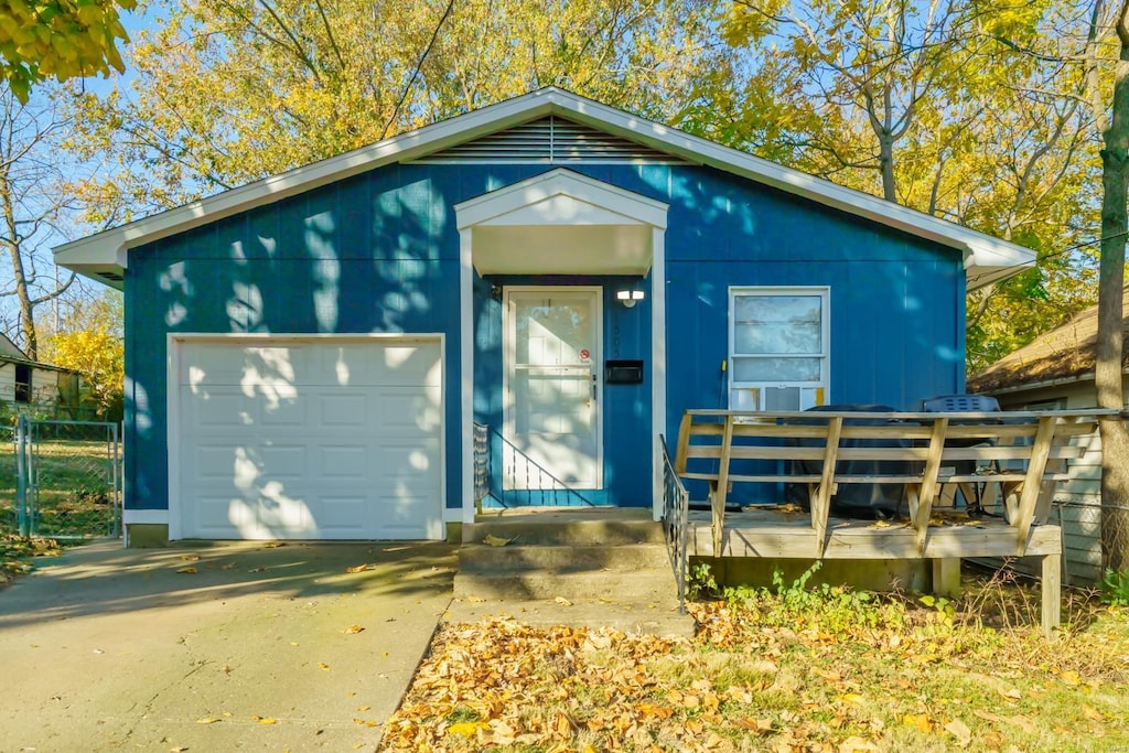 view of front of house featuring a garage and a deck