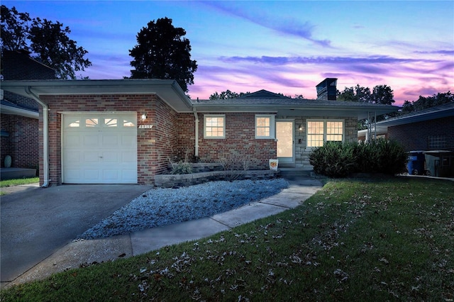 ranch-style house with a yard and a garage