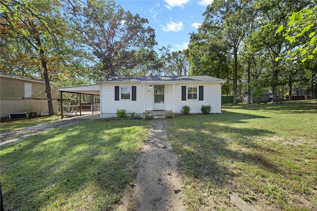 ranch-style house featuring a front lawn and a carport