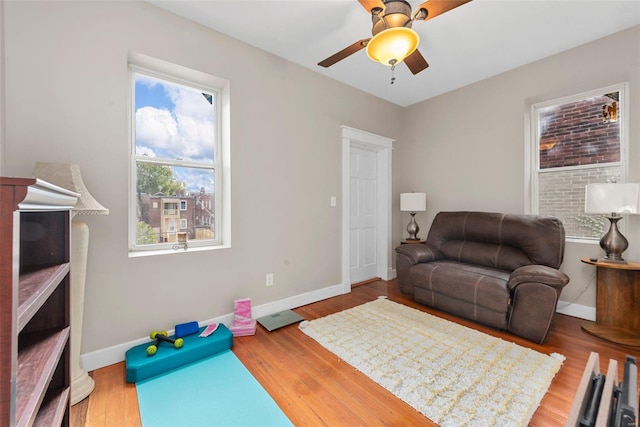 living room with hardwood / wood-style flooring and ceiling fan