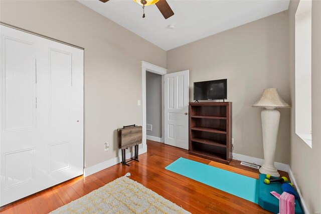 interior space featuring wood-type flooring and ceiling fan