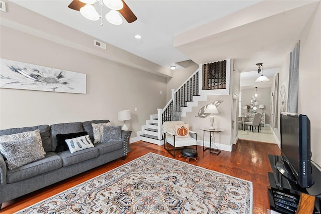 living room with ceiling fan and dark hardwood / wood-style floors