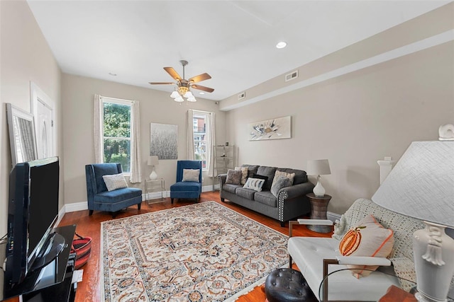 living room featuring dark hardwood / wood-style floors and ceiling fan