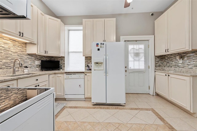 kitchen with decorative backsplash, white cabinets, sink, and white appliances