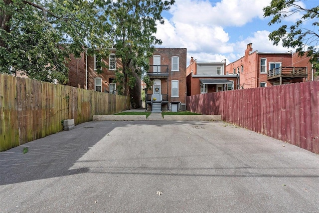 view of parking / parking lot with fence