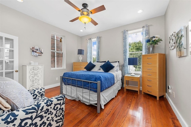 bedroom featuring wood-type flooring, baseboards, ceiling fan, and recessed lighting