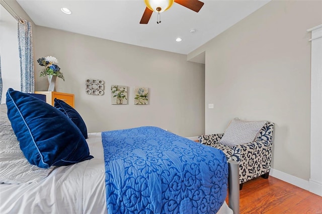 bedroom featuring a ceiling fan, baseboards, wood finished floors, and recessed lighting