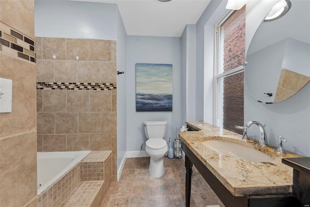 full bath featuring vanity, toilet, and baseboards