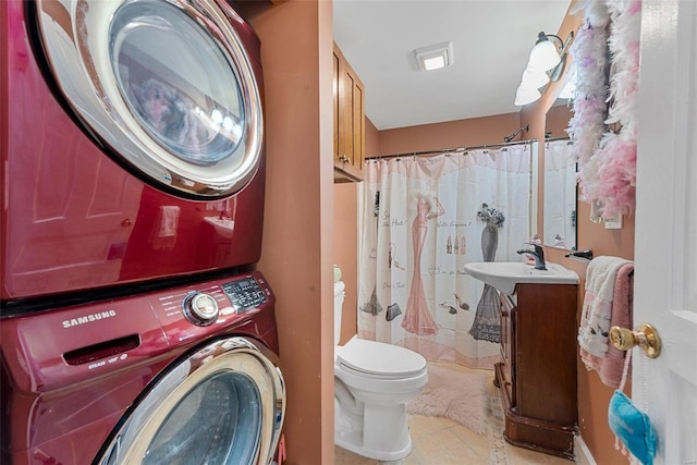 bathroom featuring toilet, tile patterned floors, vanity, stacked washer / drying machine, and a shower with curtain