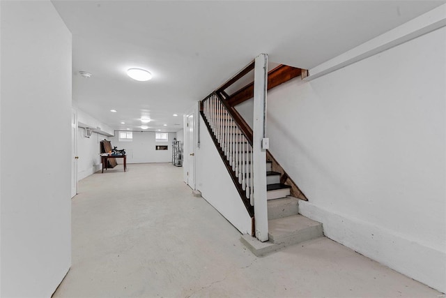 stairway featuring finished concrete flooring