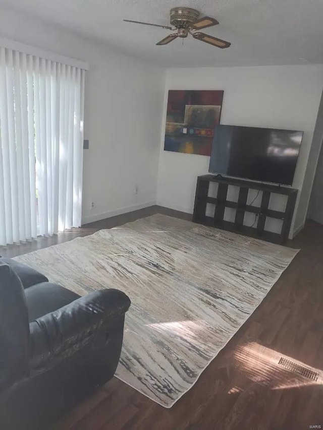 living room featuring ceiling fan and wood-type flooring