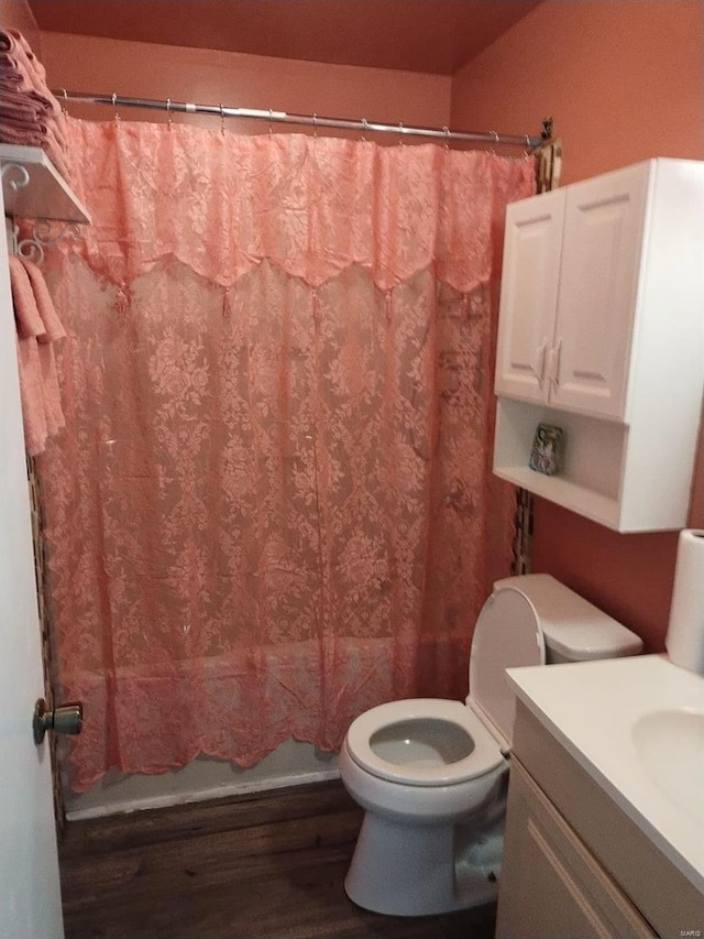 full bathroom featuring vanity, toilet, wood-type flooring, and shower / bath combo