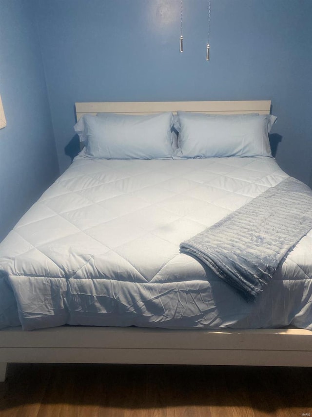 bedroom with wood-type flooring