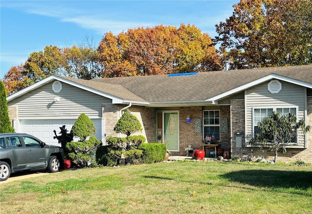 single story home with a garage and a front lawn