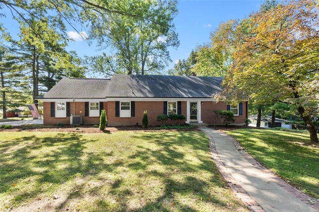 ranch-style house with a front lawn and central air condition unit