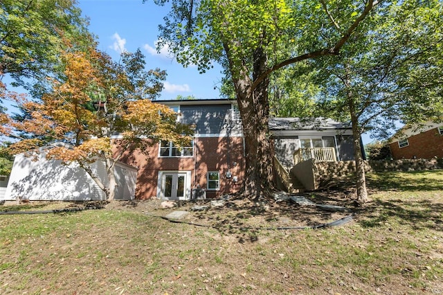 rear view of property with a yard