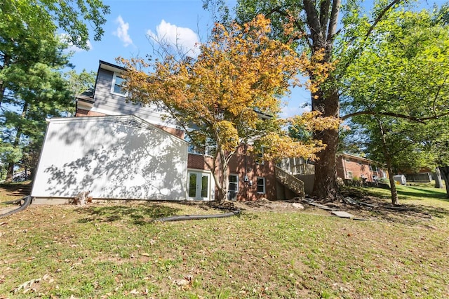 view of side of home with a yard