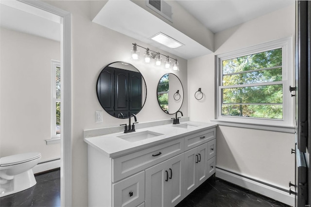 bathroom featuring vanity, a baseboard radiator, and toilet