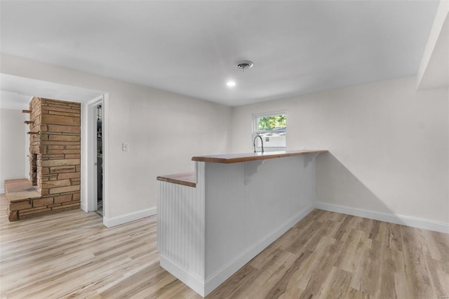 bar with light hardwood / wood-style flooring