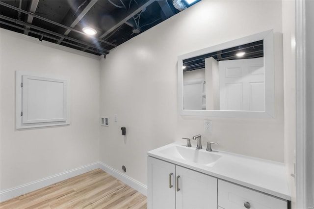 laundry room featuring light hardwood / wood-style flooring, washer hookup, and sink