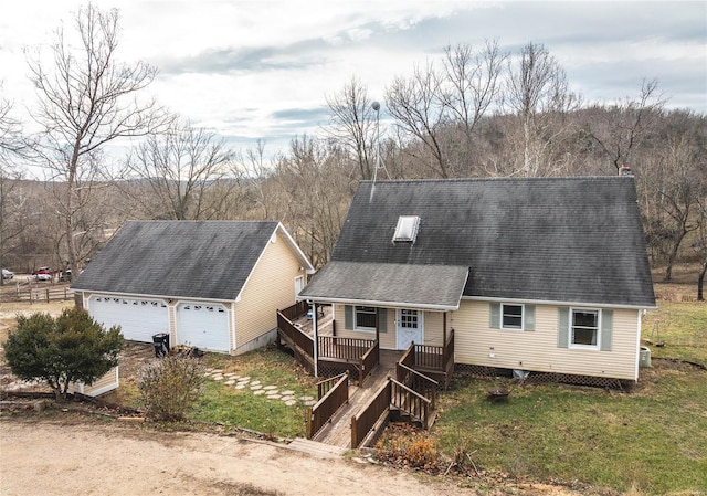 view of front of property with a garage, roof with shingles, and a wooden deck