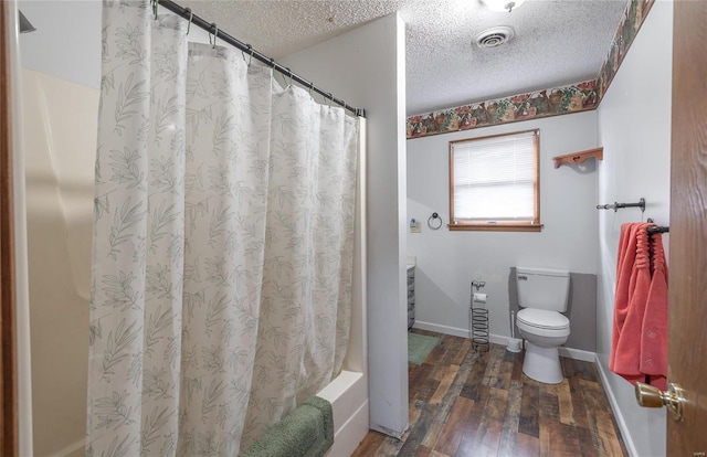 bathroom featuring a textured ceiling, hardwood / wood-style flooring, toilet, and shower / tub combo with curtain