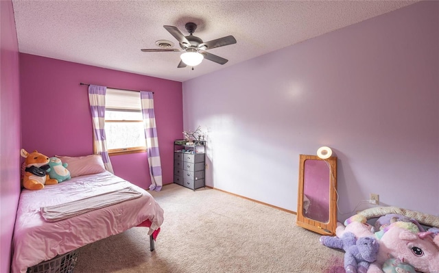 carpeted bedroom featuring ceiling fan and a textured ceiling