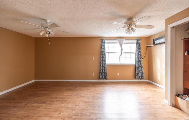 spare room with a textured ceiling, light hardwood / wood-style floors, and ceiling fan