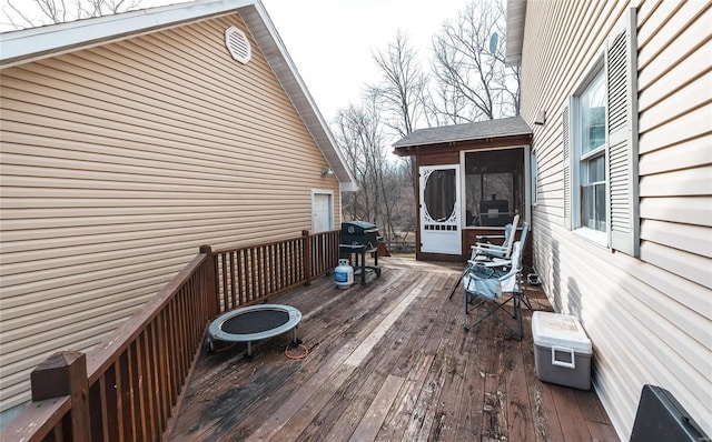 wooden terrace with grilling area and a sunroom