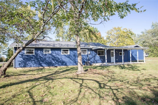 rear view of property featuring a yard and a patio area