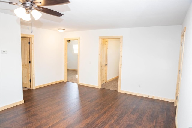 empty room with ceiling fan and dark wood-type flooring