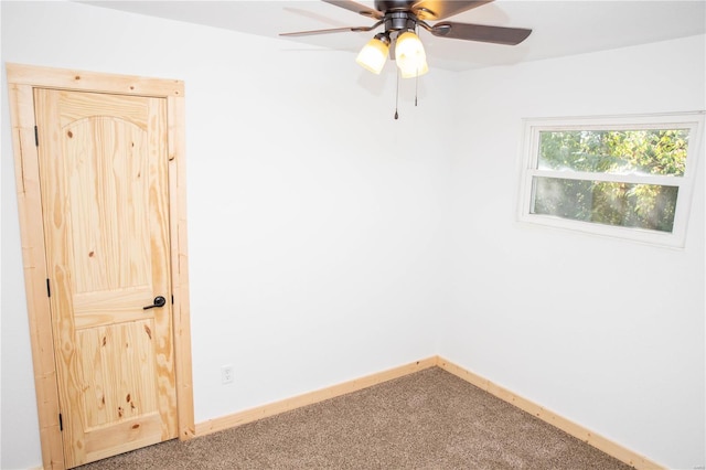 unfurnished room with ceiling fan and carpet