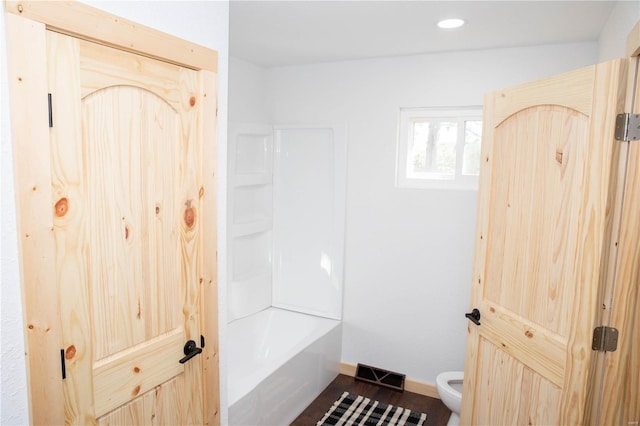 bathroom featuring hardwood / wood-style floors and toilet