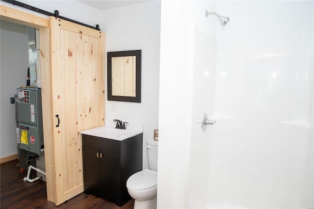 bathroom with hardwood / wood-style floors, toilet, and vanity