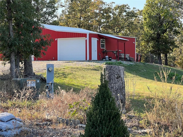 view of outbuilding with a yard and a garage