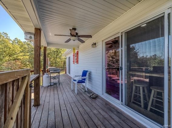 deck featuring ceiling fan and grilling area