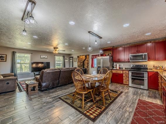 dining space featuring ceiling fan, a textured ceiling, and dark hardwood / wood-style floors