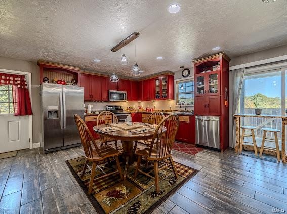 dining room featuring dark wood-type flooring and a textured ceiling