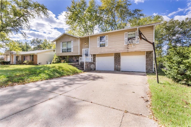 raised ranch with a front yard and a garage