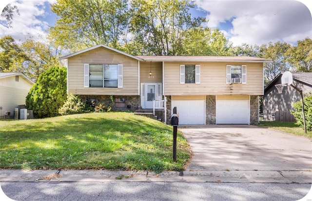 split foyer home with a front lawn and a garage